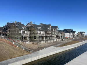 View of home's community with a water view and a residential view