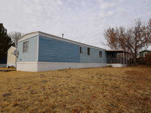 View of property exterior featuring a lawn