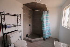 Bathroom with toilet and walk in shower