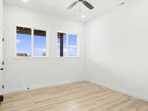 Unfurnished room with ceiling fan and light hardwood / wood-style floors