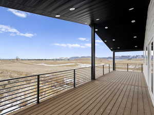 Wooden terrace featuring a mountain view and a rural view