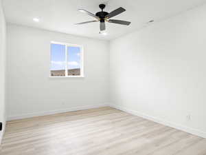 Spare room featuring light hardwood / wood-style flooring and ceiling fan