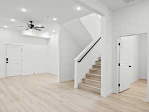 Interior space with ceiling fan and hardwood / wood-style floors