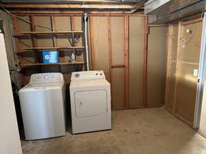 Clothes washing area featuring washing machine and dryer