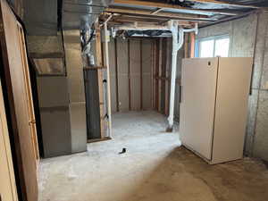 Basement with white fridge