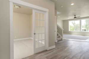 Interior space with ceiling fan and wood-type flooring