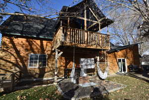 Rear view of property featuring a patio area and a deck