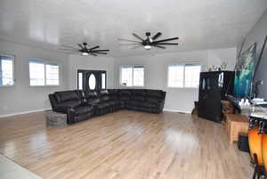 Living room featuring light hardwood / wood-style floors and a textured ceiling