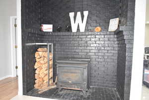 Interior details featuring a wood stove and wood-type flooring