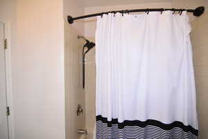 Bathroom with shower / bath combo with shower curtain