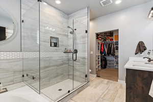 Bathroom with vanity and a shower with shower door