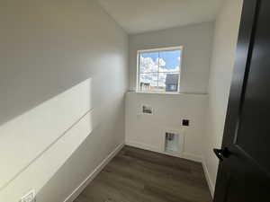 Washroom featuring electric dryer hookup, dark hardwood / wood-style floors, and washer hookup