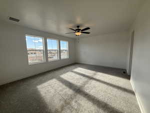 Unfurnished room with carpet flooring, a textured ceiling, and ceiling fan