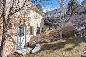 View of side of home with stone siding and stucco siding