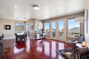 Dining area featuring a wealth of natural light, baseboards, and wood finished floors