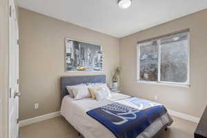 Carpeted bedroom with baseboards