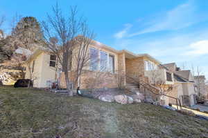 View of home's exterior featuring a lawn and stucco siding