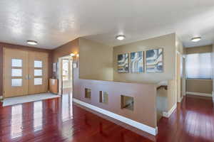 Foyer entrance featuring french doors, wood-type flooring, and baseboards