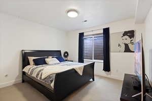 Carpeted bedroom featuring baseboards