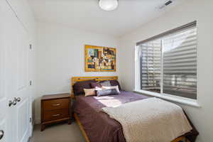 Bedroom featuring visible vents and light colored carpet