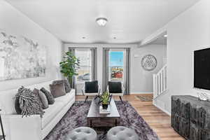 Living room with hardwood / wood-style flooring and a textured ceiling