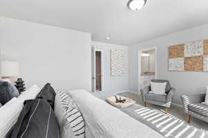 Bedroom featuring carpet flooring and ensuite bathroom