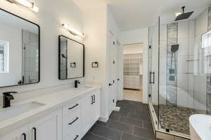 Primary Bathroom featuring tile patterned flooring, vanity, a shower with door, and plenty of natural light