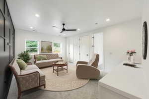 Upper great room loft area Carpeted great room with ceiling fan and a textured ceiling