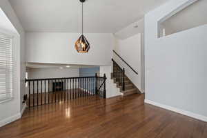 Interior space featuring dark hardwood / wood-style flooring and lofted ceiling