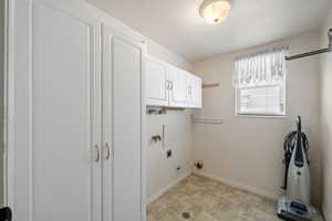 Laundry area featuring cabinets and hookup for an electric dryer