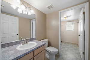 Bathroom featuring vanity and toilet