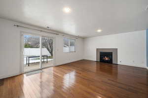 Unfurnished living room with a textured ceiling and hardwood / wood-style flooring