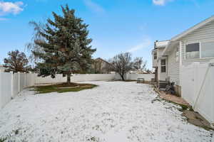 Snowy yard with central AC