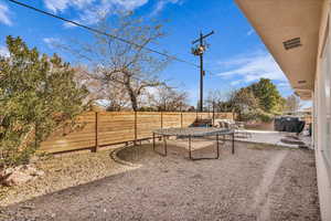 View of yard with a patio area and a trampoline