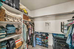 Walk in closet featuring light carpet