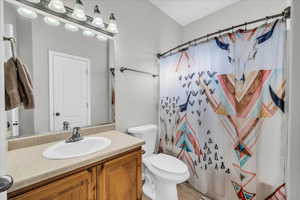 Bathroom with tile patterned floors, vanity, and toilet