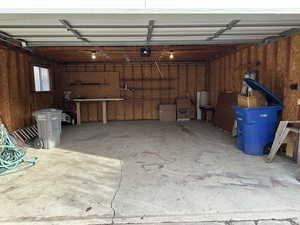 Extra wide, extra deep and extra tall Garage with a garage door opener and work bench and shelves in back