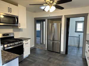 Kitchen featuring stainless steel appliances and 12'X18" slate tile flooring