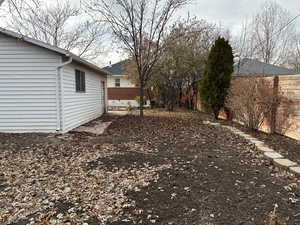 North area of backyard looking west with garage to the left and the house on the west end