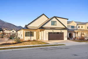 View of front of home featuring a mountain view and a garage