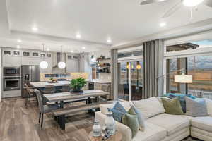 Living room featuring ceiling fan and wood-type flooring