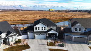 View of front of property featuring a water and mountain view and a garage