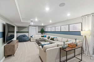 Carpeted living room featuring a textured ceiling