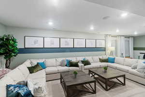 Living room featuring light colored carpet and a textured ceiling