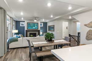 Dining space with ceiling fan and hardwood / wood-style flooring