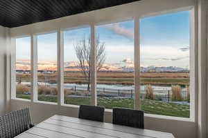 Dining area with a water and mountain view