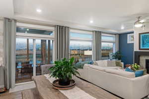 Living room with wood-type flooring and ceiling fan