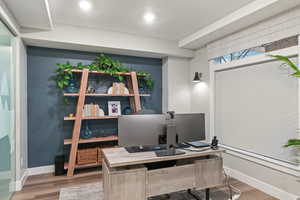 Office space with a textured ceiling and hardwood / wood-style flooring