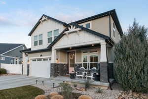 Craftsman house featuring a porch and a garage