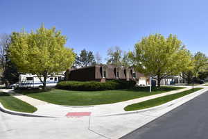 View of property exterior featuring a yard and a shingled roof